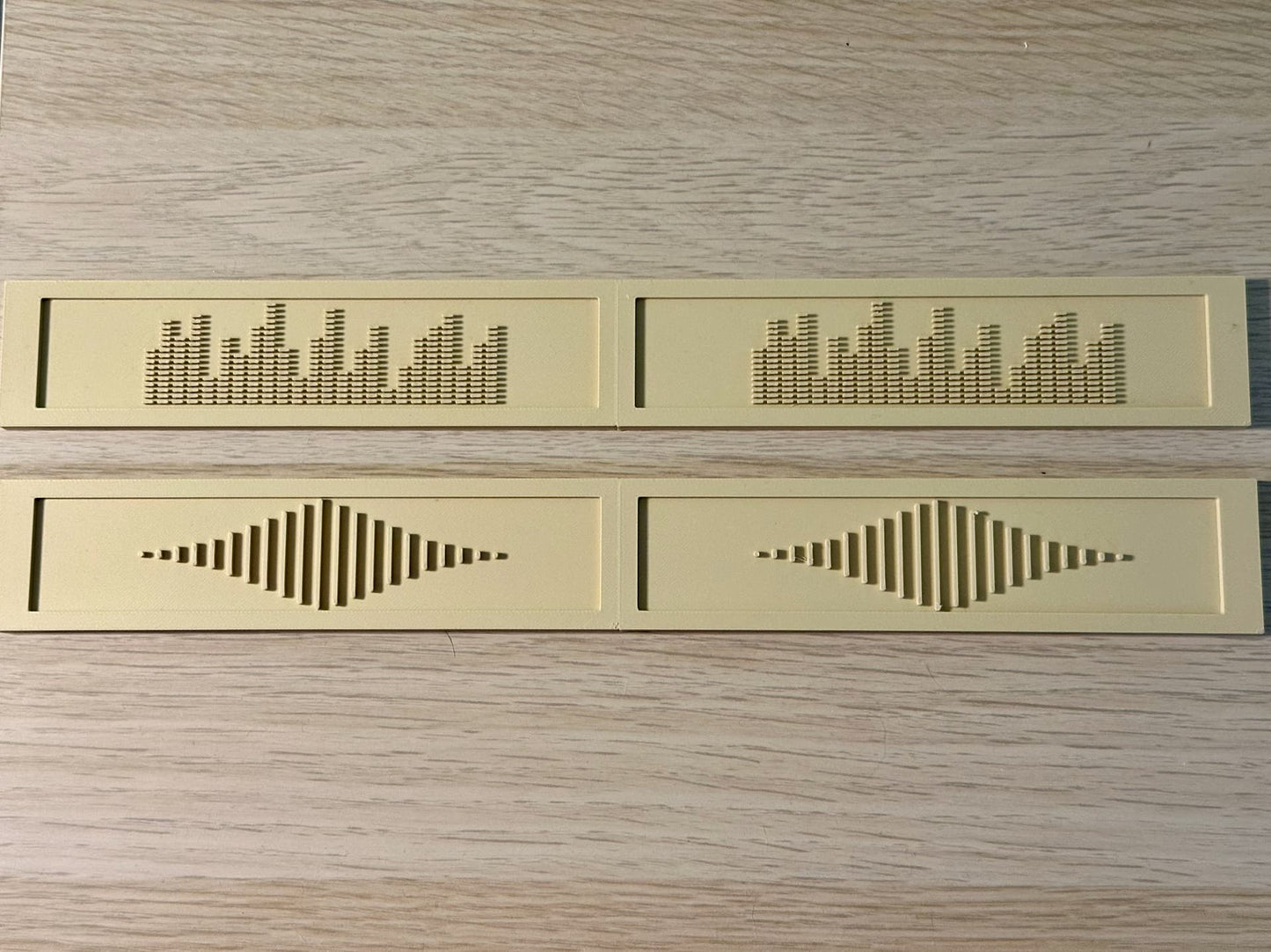 Beige deluxe backspacers with the EQ and Sound Wave designs displayed on top of a white oak IKEA Kallax shelf. 