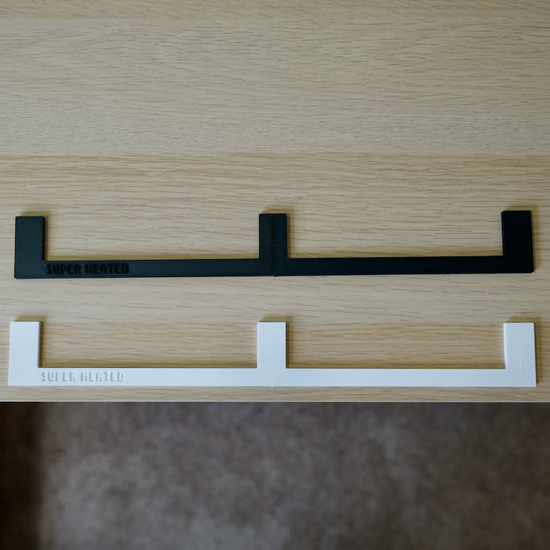 Basic Backspacers in black and white displayed on top of a white oak Ikea shelf
