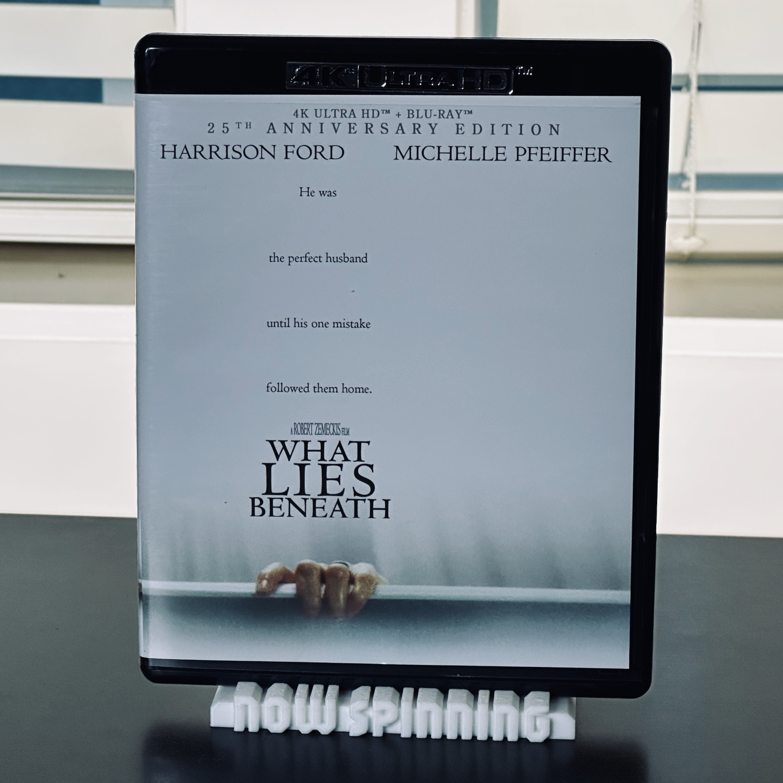 View of the white "Now Spinning" display stand with a 4K DVD case in place.