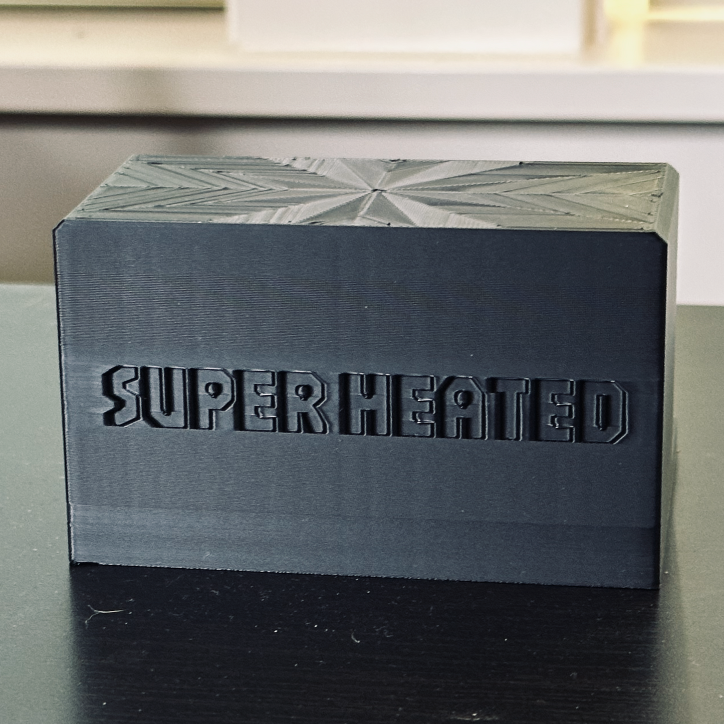Rear view of the black record display stand with "Super Heated" embossed in it.