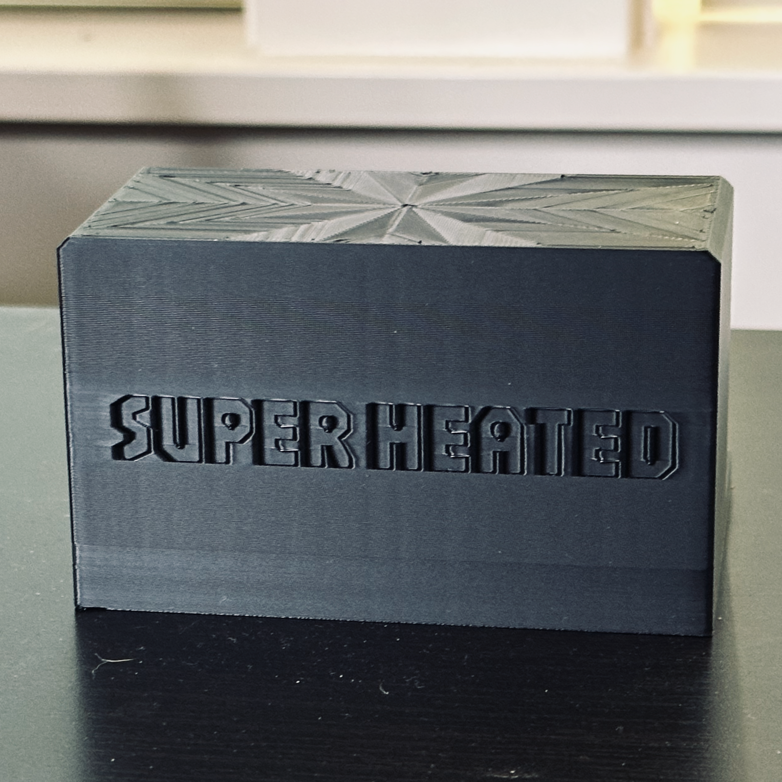 Rear view of the black record display stand with "Super Heated" embossed in it.