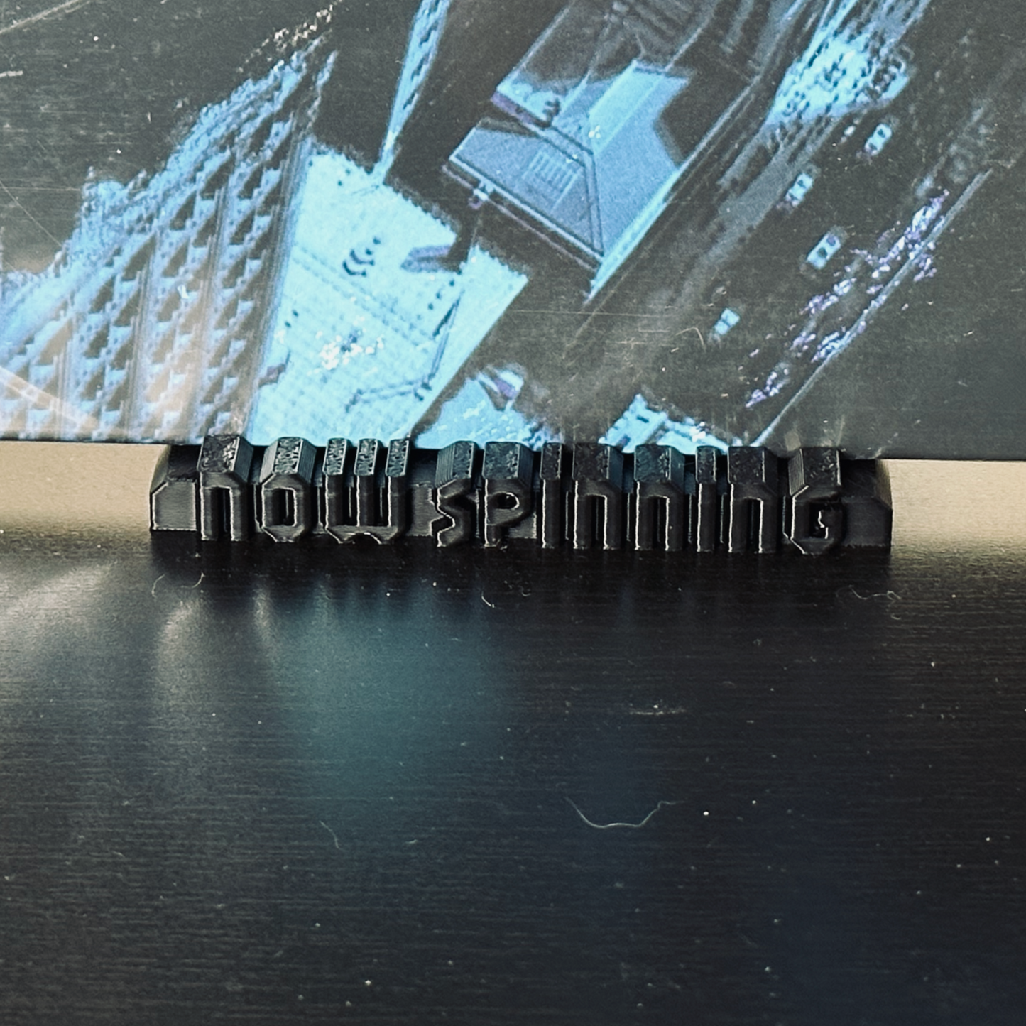 Closeup of the black "Now Spinning" display stand with a record in place.