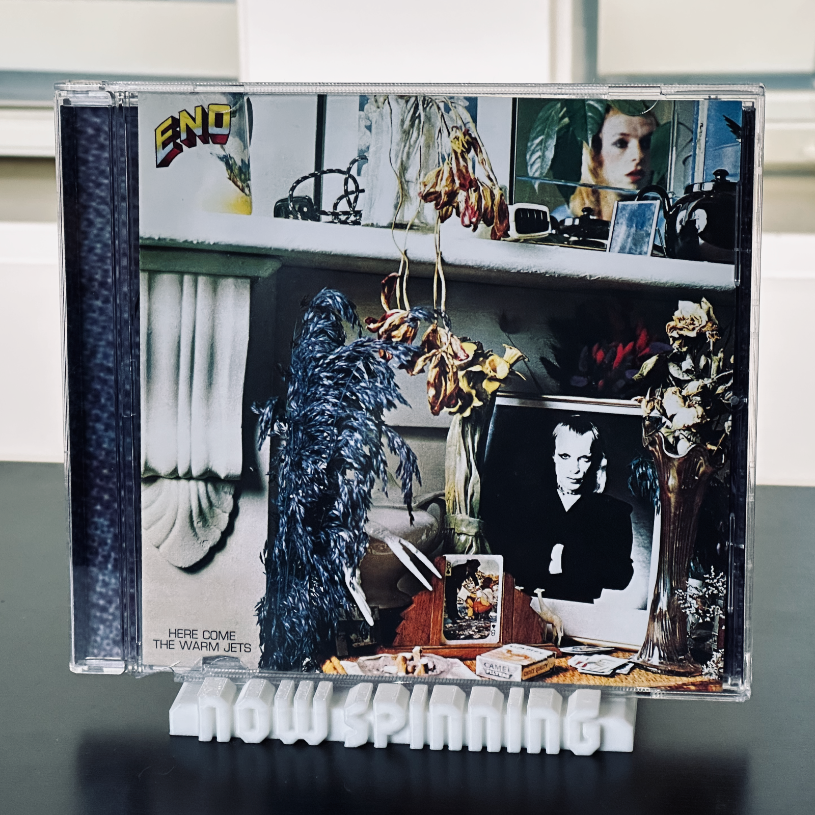 View of the white "Now Spinning" display stand with a CD jewel case in place.