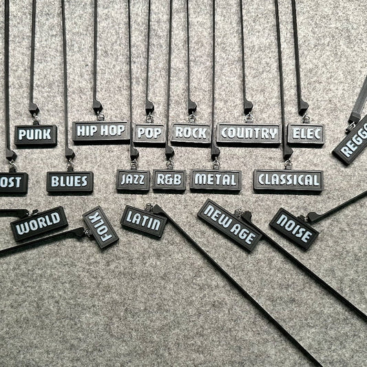 3D-printed music genre shelf tags in black with white letters
