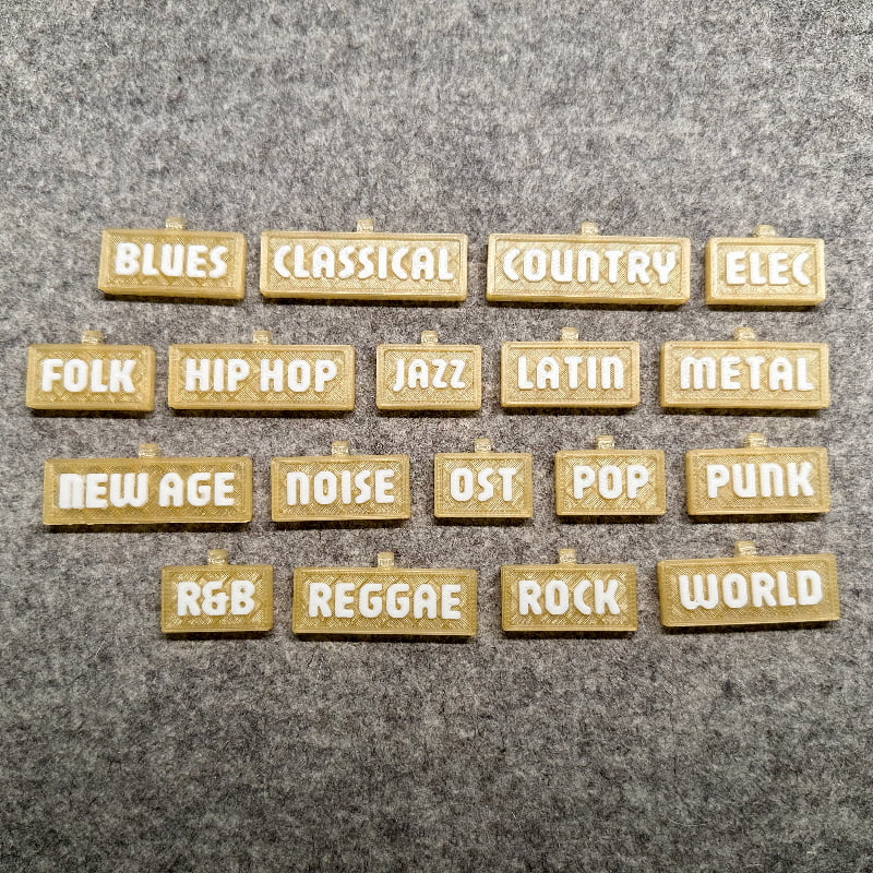 3D-printed music genre shelf tags in gold with white letters