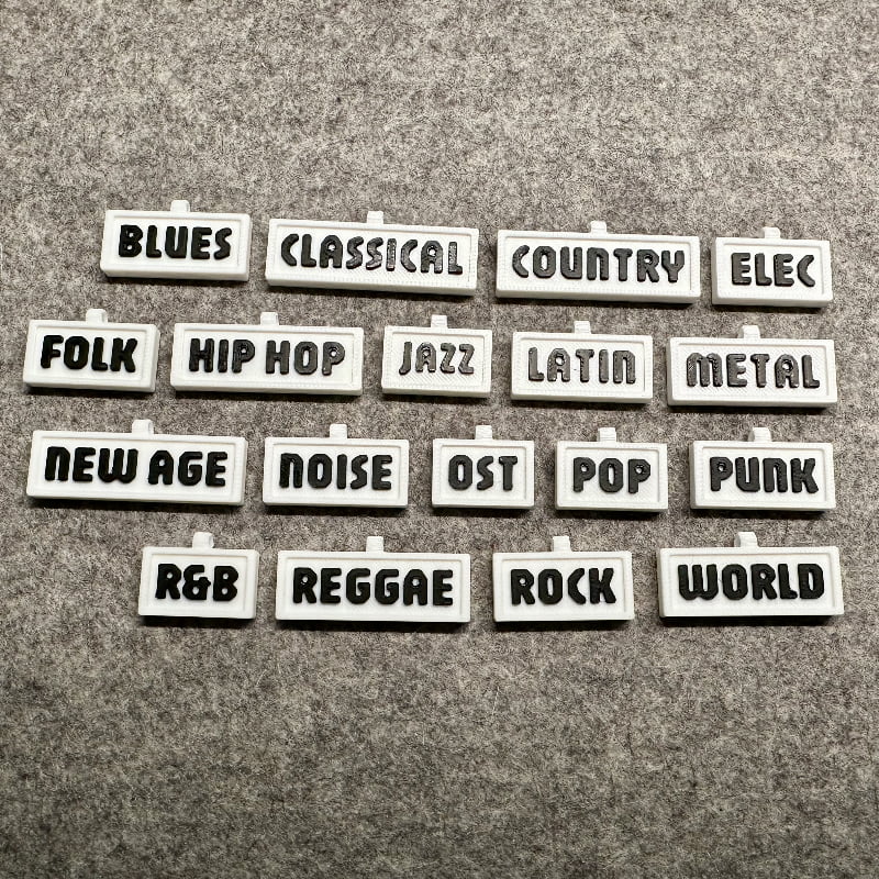 3D-printed music genre shelf tags in white with black letters