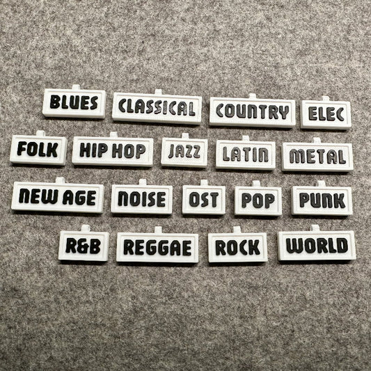 3D-printed music genre shelf tags in white with black letters