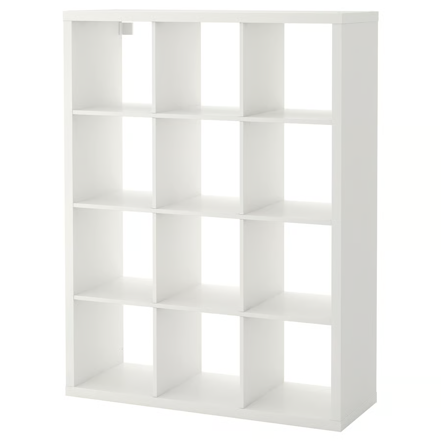 A white Ikea Kallax shelf with 12 storage spaces.