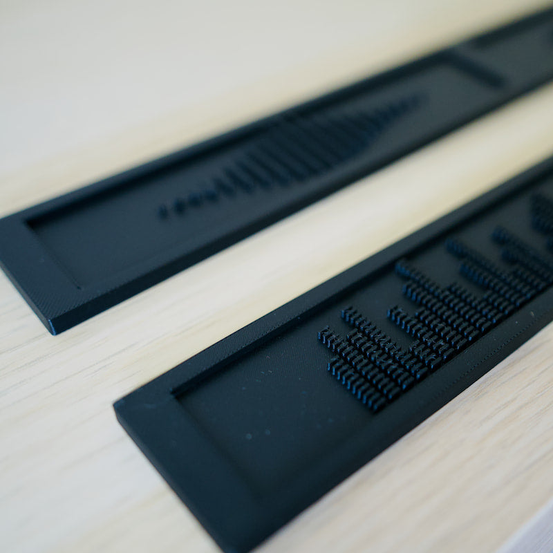 Closeup of the Deluxe Backspacers with the EQ and Soundwave designs